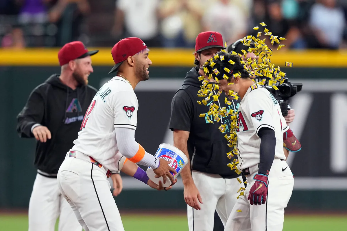 May 21, 2026; Phoenix, Arizona, USA; Arizona Diamondbacks right fielder Corbin Carroll (7) is doused with gum by Arizona Diamondbacks left fielder Lourdes Gurriel Jr. (12) after hitting a walk off single against the Colorado Rockies during the ninth inning at Chase Field. Mandatory Credit: Joe Camporeale-Imagn Images