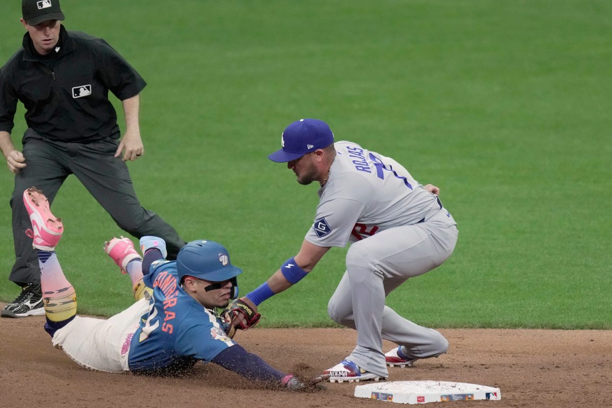 Milwaukee Brewers catcher William Contreras (24) is tagged out by Los Angeles Dodgers shortstop Miguel Rojas (72) while trying to steal second base during the seventh inning of their game Friday, May 22, 2026 at American Family Field in Milwaukee, Wisconsin.