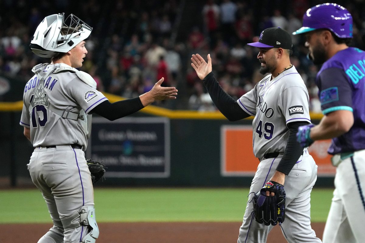 May 22, 2026; Phoenix, Arizona, USA; Colorado Rockies catcher Hunter Goodman (15) and pitcher Antonio Senzatela (49) celebrate after defeating the Arizona Diamondbacks in the fifth inning at Chase Field. Mandatory Credit: Rick Scuteri-Imagn Images