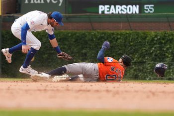 May 23, 2026; Chicago, Illinois, USA; Chicago Cubs shortstop Dansby Swanson (7) tags out Houston Astros center fielder Brice Matthews (0) at second base on a steal attempt during the ninth inning  at Wrigley Field. Mandatory Credit: David Banks-Imagn Images