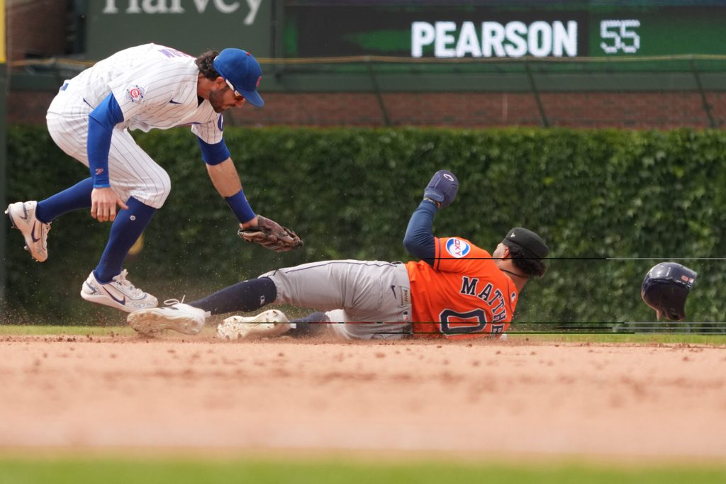 May 23, 2026; Chicago, Illinois, USA; Chicago Cubs shortstop Dansby Swanson (7) tags out Houston Astros center fielder Brice Matthews (0) at second base on a steal attempt during the ninth inning at Wrigley Field. Mandatory Credit: David Banks-Imagn Images
