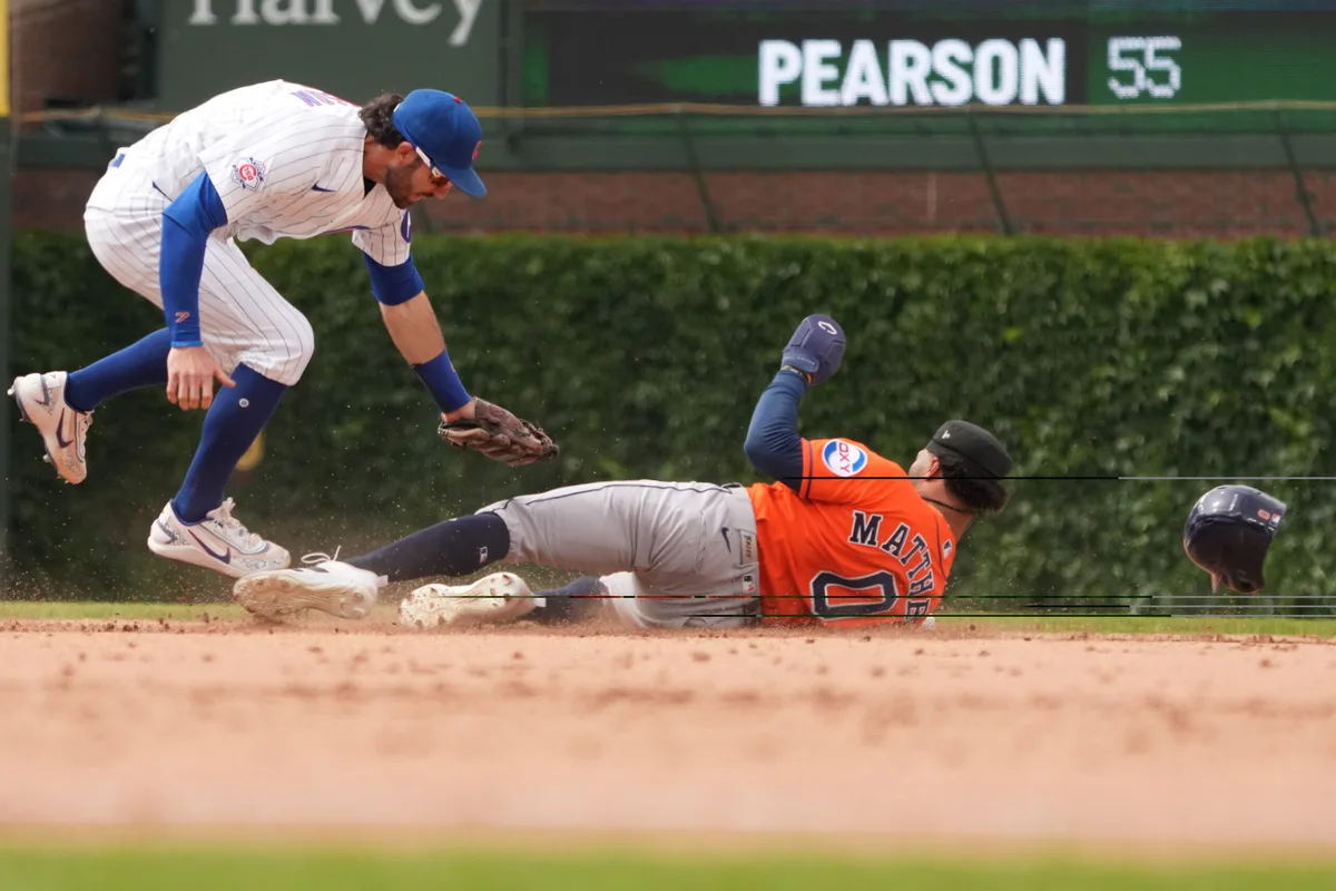 May 23, 2026; Chicago, Illinois, USA; Chicago Cubs shortstop Dansby Swanson (7) tags out Houston Astros center fielder Brice Matthews (0) at second base on a steal attempt during the ninth inning at Wrigley Field. Mandatory Credit: David Banks-Imagn Images