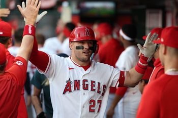 May 23, 2026; Anaheim, California, USA;  Los Angeles Angels center fielder Mike Trout (27) is greeted in the dugout after hitting a two-run home run during the first inning against the Texas Rangers at Angel Stadium. Mandatory Credit: Kiyoshi Mio-Imagn Images