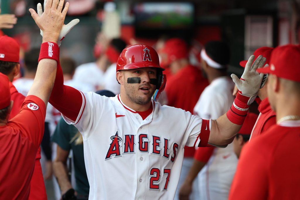 May 23, 2026; Anaheim, California, USA; Los Angeles Angels center fielder Mike Trout (27) is greeted in the dugout after hitting a two-run home run during the first inning against the Texas Rangers at Angel Stadium. Mandatory Credit: Kiyoshi Mio-Imagn Images