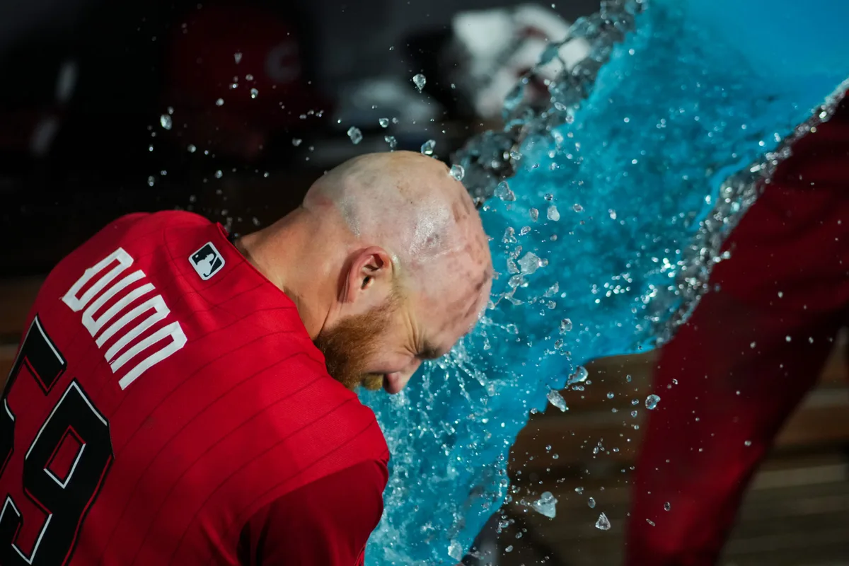 May 23, 2026; Cincinnati, Ohio, USA; Cincinnati Reds outfielder Blake Dunn is doused with Powerade by shortstop Elly de la Cruz after defeating the St. Louis Cardinals at Great American Ball Park. Mandatory Credit: Aaron Doster-Imagn Images
