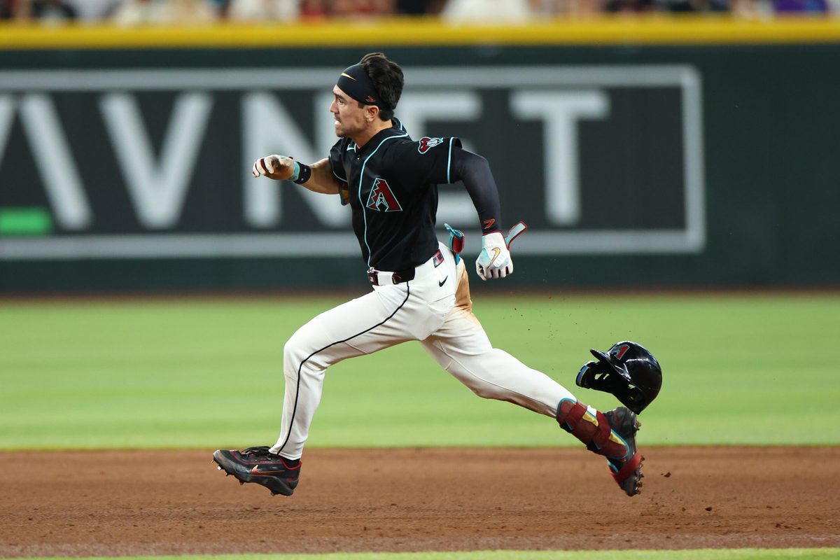May 24, 2026; Phoenix, Arizona, USA; Arizona Diamondbacks right fielder Corbin Carroll (7) runs while hitting a triple against Colorado Rockies pitcher Seth Halvorsen (54) in the sixth inning at Chase Field. Mandatory Credit: Anna Carrington-Imagn Images