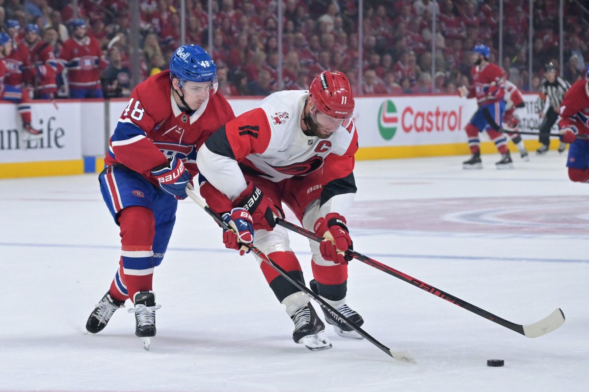 May 25, 2026; Montreal, Quebec, CAN; Montreal Canadiens defenseman Lane Hutson (48) and Carolina Hurricanes center Jordan Staal (11) battle for the puck during the second period in game three of the Eastern Conference Final of the 2026 Stanley Cup Playoffs at Bell Centre. Mandatory Credit: Eric Bolte-Imagn Images