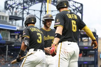 May 26, 2026; Pittsburgh, Pennsylvania, USA;  Pittsburgh Pirates third baseman Nick Gonzales (3) and shortstop Konnor Griffin (6) greet second baseman Brandon Lowe (middle) crossing home plate and scoring a run against the Chicago Cubs during the first inning at PNC Park. Mandatory Credit: Charles LeClaire-Imagn Images