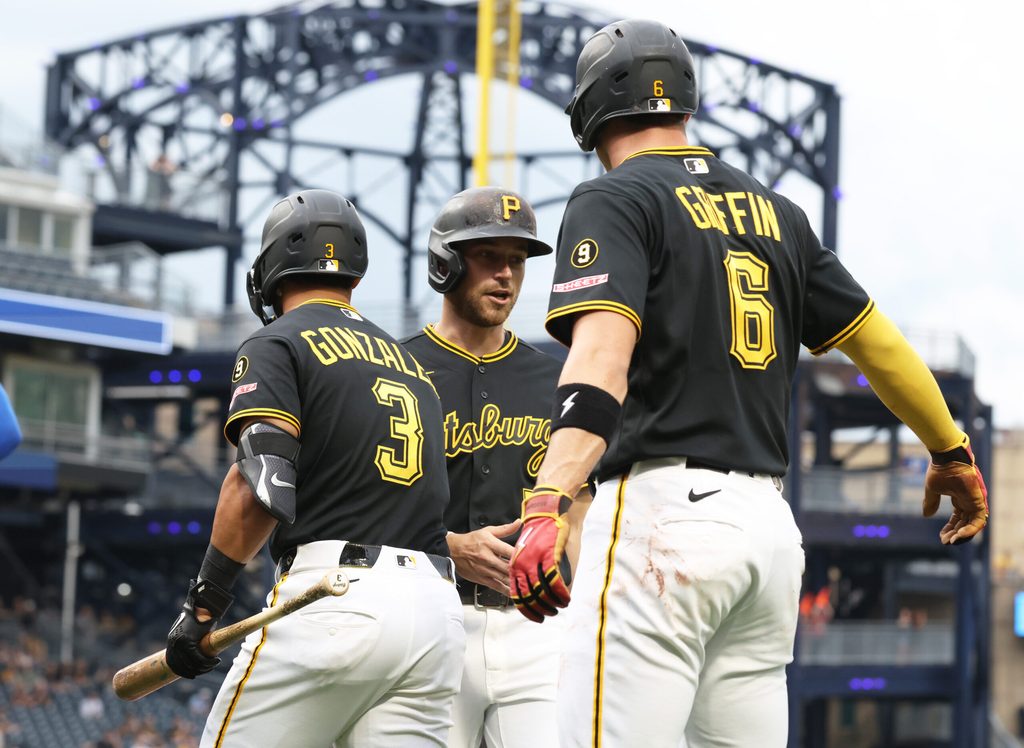 May 26, 2026; Pittsburgh, Pennsylvania, USA; Pittsburgh Pirates third baseman Nick Gonzales (3) and shortstop Konnor Griffin (6) greet second baseman Brandon Lowe (middle) crossing home plate and scoring a run against the Chicago Cubs during the first inning at PNC Park. Mandatory Credit: Charles LeClaire-Imagn Images