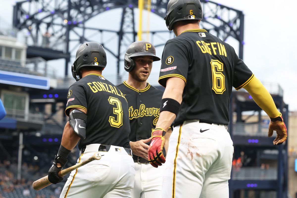 May 26, 2026; Pittsburgh, Pennsylvania, USA; Pittsburgh Pirates third baseman Nick Gonzales (3) and shortstop Konnor Griffin (6) greet second baseman Brandon Lowe (middle) crossing home plate and scoring a run against the Chicago Cubs during the first inning at PNC Park. Mandatory Credit: Charles LeClaire-Imagn Images