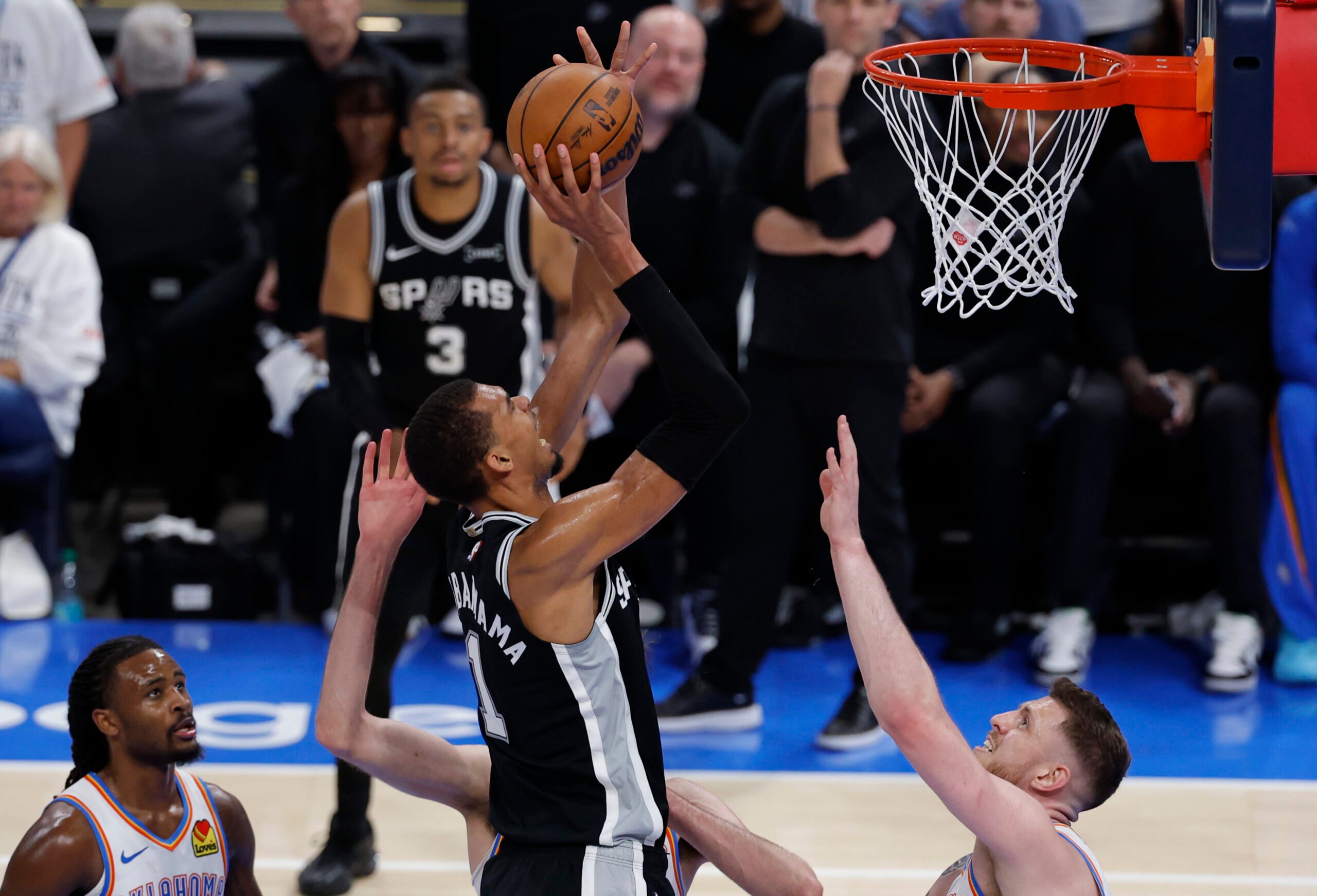 May 26, 2026; Oklahoma City, Oklahoma, USA; San Antonio Spurs forward Victor Wembanyama (1) shoots against Oklahoma City Thunder center Isaiah Hartenstein (55) during the fourth quarter in game five of the western conference finals for the 2026 NBA playoffs at Paycom Center. Mandatory Credit: Alonzo Adams-Imagn Images