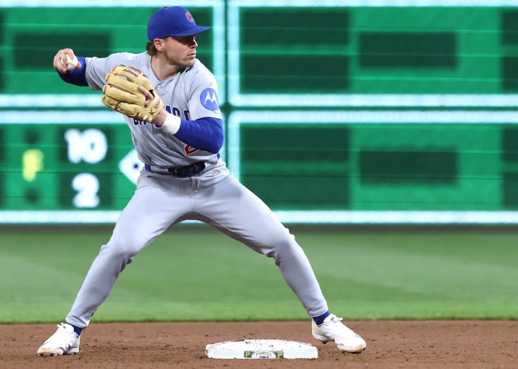 May 28, 2026; Pittsburgh, Pennsylvania, USA; Chicago Cubs second baseman Nico Hoerner (2) throws to first base to complete a double play against the Pittsburgh Pirates during the ninth inning at PNC Park. Mandatory Credit: Charles LeClaire-Imagn Images