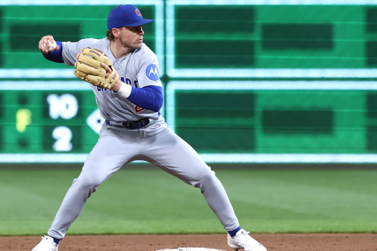 May 28, 2026; Pittsburgh, Pennsylvania, USA; Chicago Cubs second baseman Nico Hoerner (2) throws to first base to complete a double play against the Pittsburgh Pirates during the ninth inning at PNC Park. Mandatory Credit: Charles LeClaire-Imagn Images