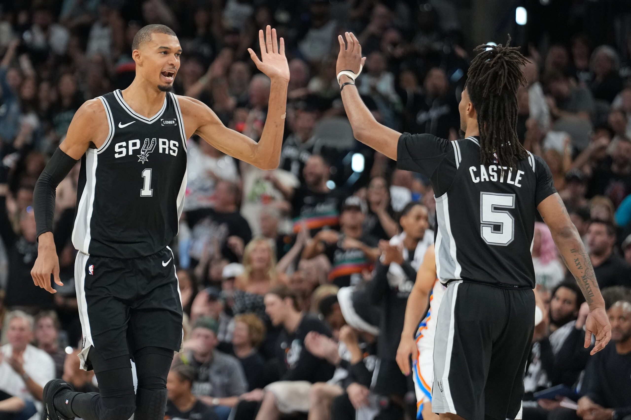 May 28, 2026; San Antonio, Texas, USA; San Antonio Spurs forward Victor Wembanyama (1) reacts with guard Stephon Castle (5) in the second half during game six of the western conference finals for the 2026 NBA playoffs at Frost Bank Center. Mandatory Credit: Daniel Dunn-Imagn Images