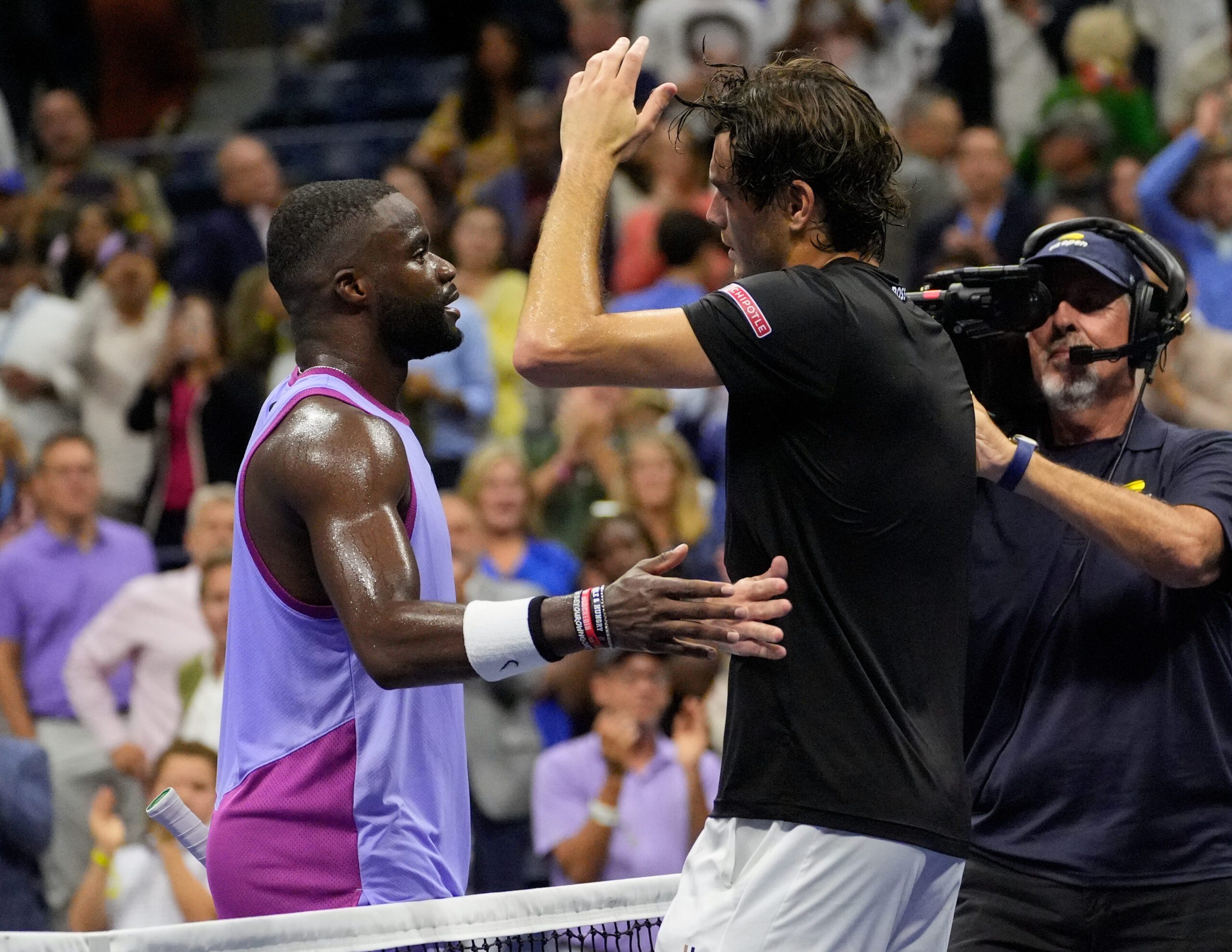 Sept 6, 2024; Flushing, NY, USA; Taylor Fritz (USA) (right) after beating Frances Tiafoe (USA) in the men's semifinals on day twelve of the 2024 U.S. Open tennis tournament at USTA Billie Jean King National Tennis Center. Mandatory Credit: Robert Deutsch-Imagn Images
