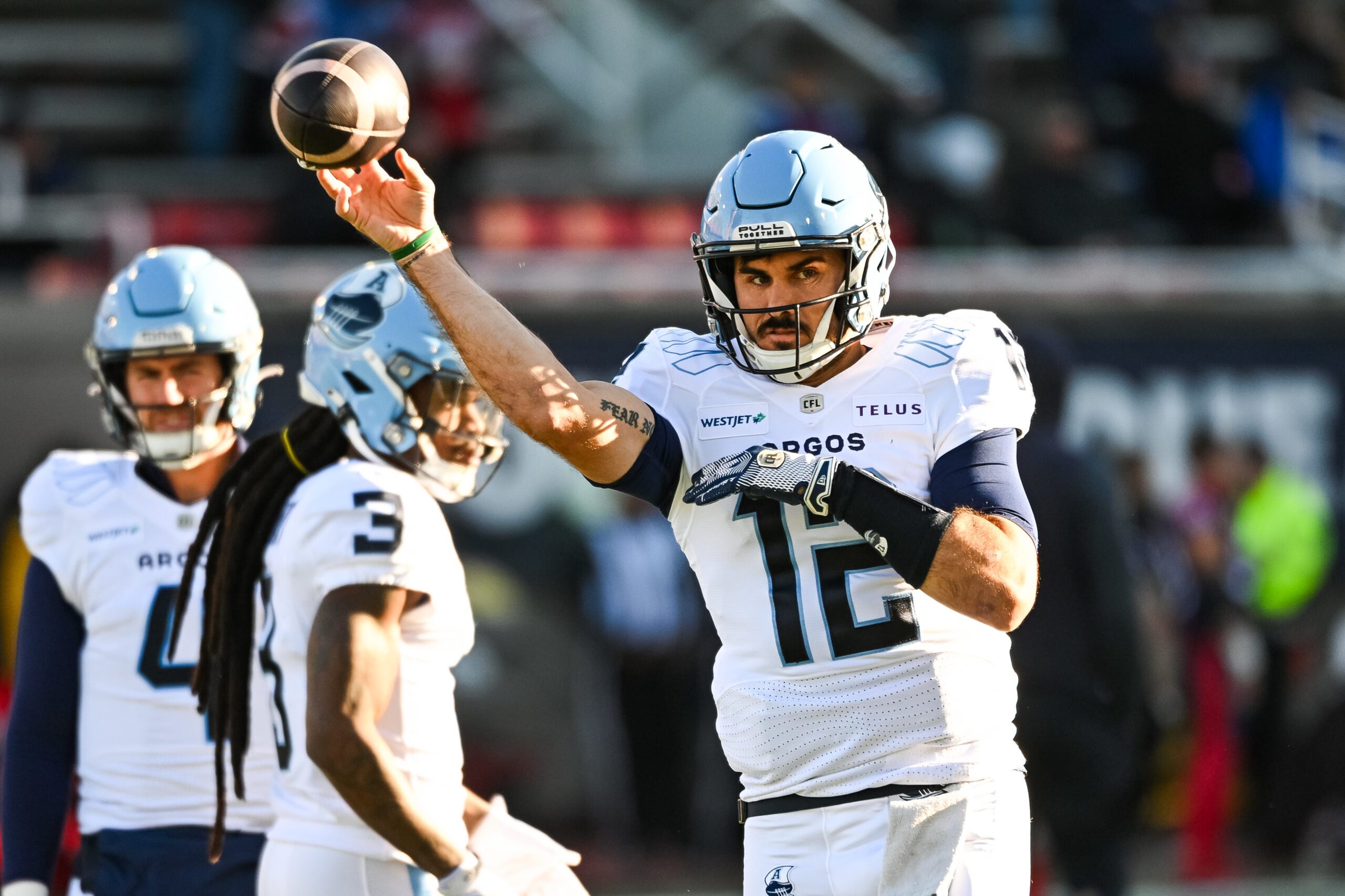 Nov 9, 2024; Montreal, Quebec, CAN; Toronto Argonauts quarterback Chad Kelly (12) throws a ball during warm-up before the game against the Montreal Alouettes  at Percival-Molson Memorial Stadium. Mandatory Credit: David Kirouac-Imagn Images