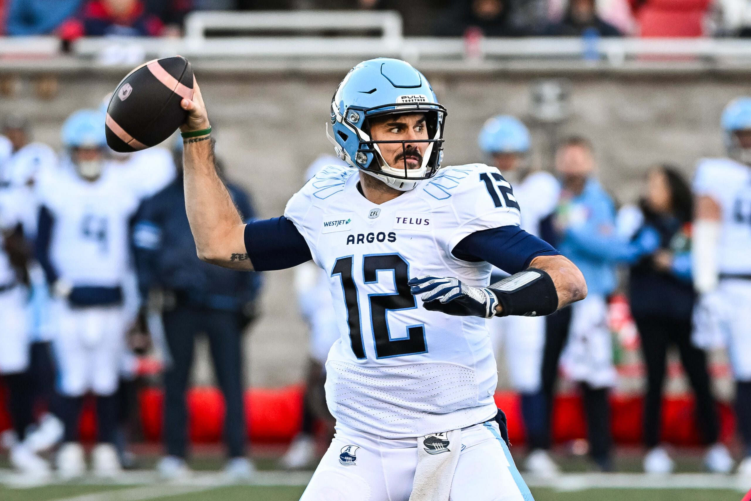 Nov 9, 2024; Montreal, Quebec, CAN; Toronto Argonauts quarterback Chad Kelly (12) passes the ball against the Montreal Alouettes during the first quarter at Percival-Molson Memorial Stadium. Mandatory Credit: David Kirouac-Imagn Images