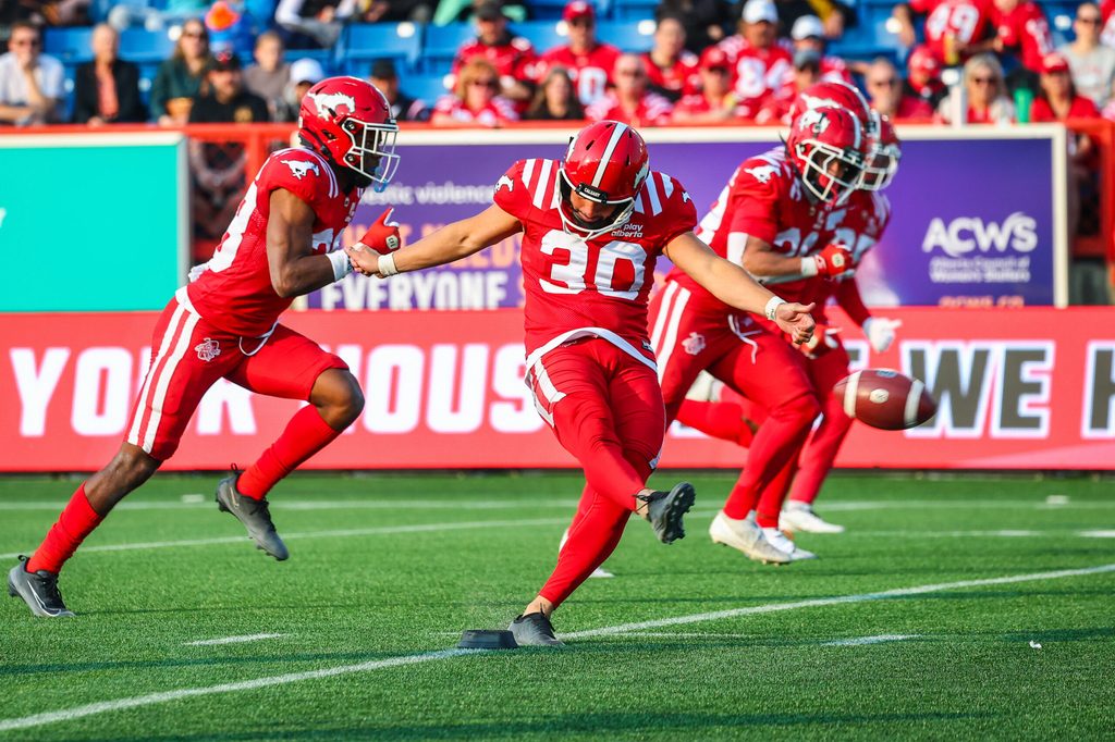 Jun 7, 2025; Calgary, Alberta, Canada; Calgary Stampeders kicker Rene Paredes (30) kicks the ball against the Hamilton Tiger-Cats during the second half at McMahon Stadium. Mandatory Credit: Sergei Belski-Imagn Images