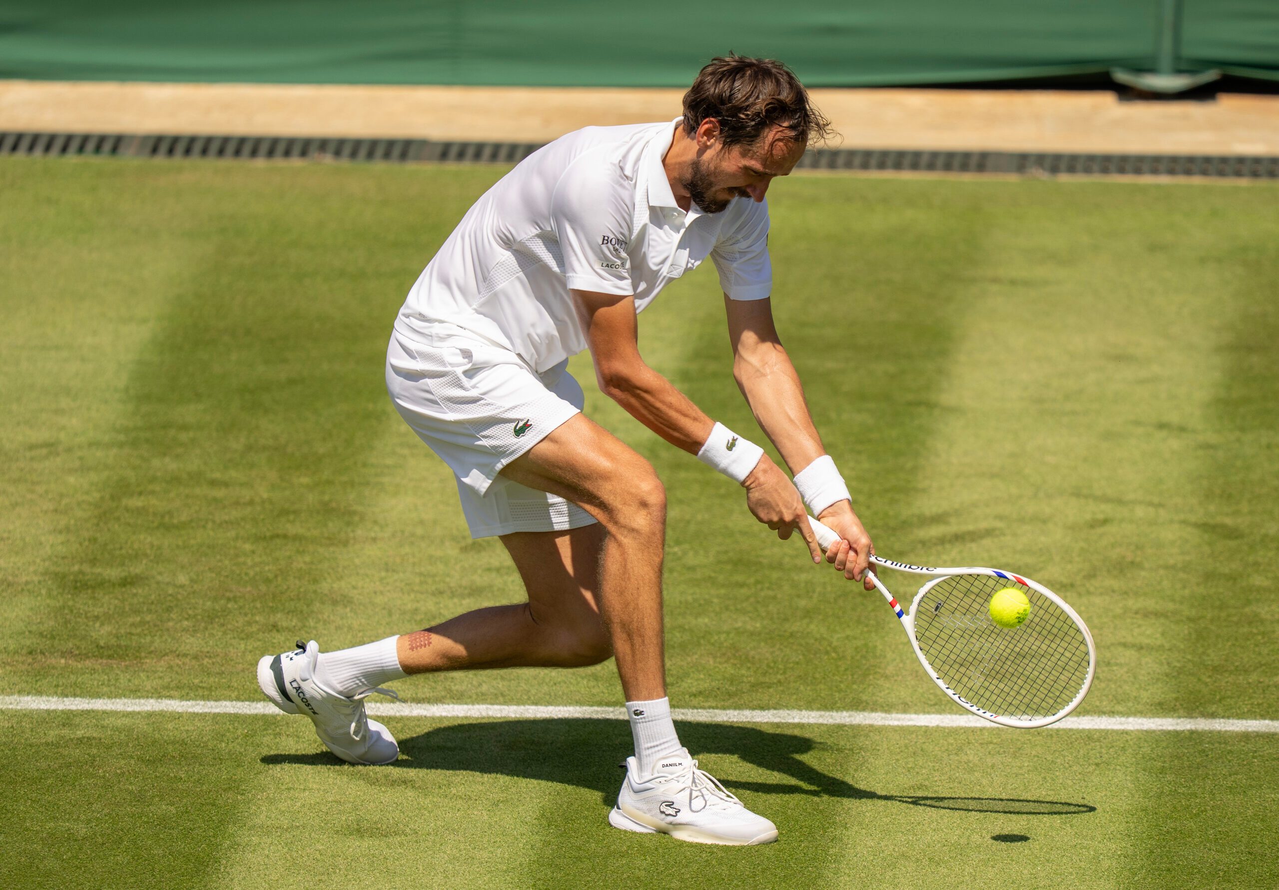 Jun 30, 2025; Wimbledon, UNITED KINGDOM; Daniil Medvedev returns a shot during his match against Benjamin Bonzi of France on day one at the All England Lawn Tennis and Croquet Club. Mandatory Credit: Susan Mullane-Imagn Images