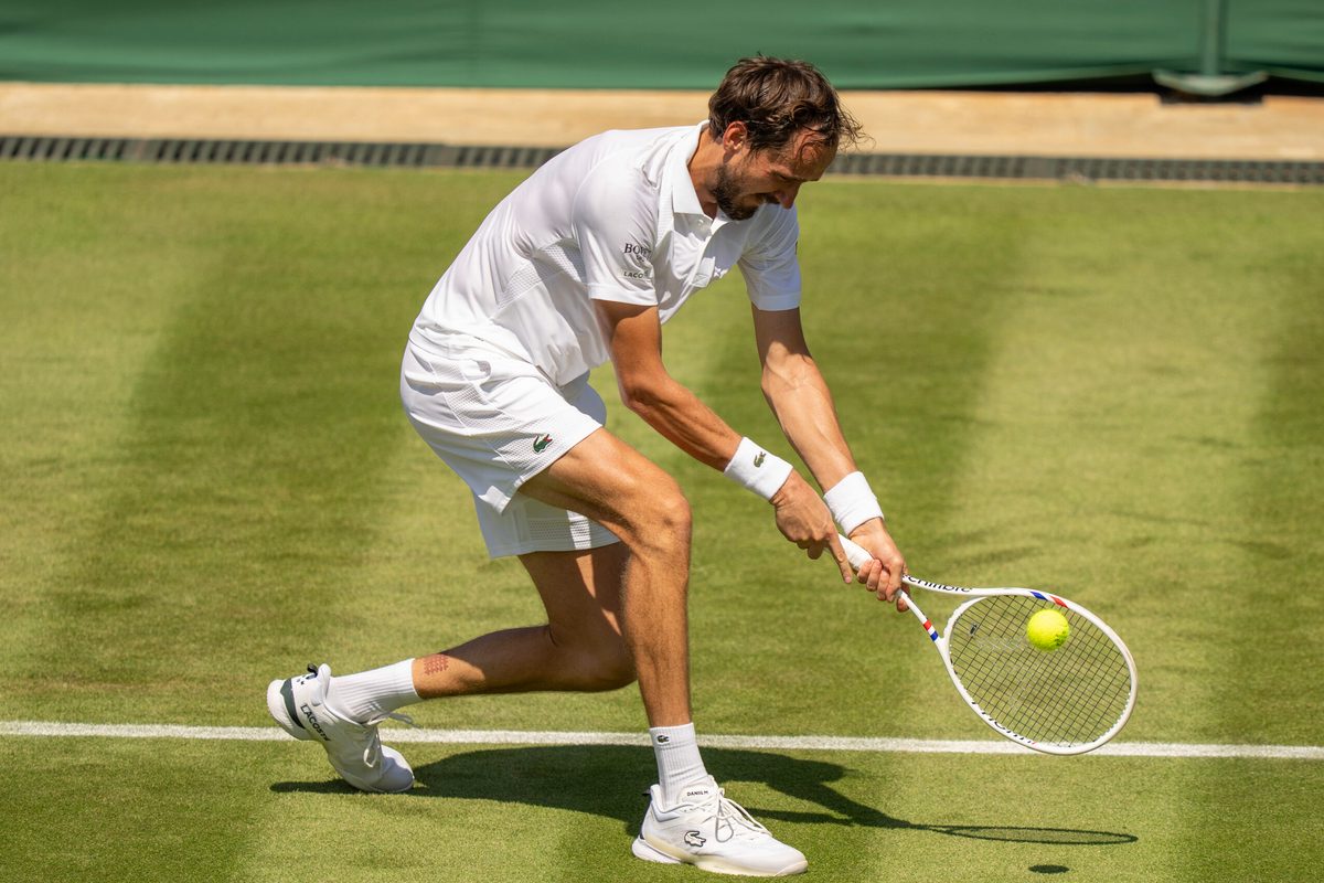 Jun 30, 2025; Wimbledon, UNITED KINGDOM; Daniil Medvedev returns a shot during his match against Benjamin Bonzi of France on day one at the All England Lawn Tennis and Croquet Club. Mandatory Credit: Susan Mullane-Imagn Images