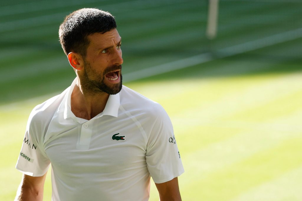 Jul 9, 2025; Wimbledon, United Kingdom; Novak Djokovic (SRB) reacts towards his player's box after losing a point against Flavio Cobolli (ITA)(not pictured) in a gentlemen's singles quarter-final on day ten of these Championships Wimbledon 2025 at All England Lawn Tennis and Croquet Club. Mandatory Credit: Geoff Burke-Imagn Images
