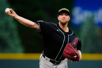 May 15, 2026; Denver, Colorado, USA; Arizona Diamondbacks starting pitcher Merrill Kelly (29) delivers a pitch in the first inning against the Colorado Rockies at Coors Field. Mandatory Credit: Ron Chenoy-Imagn Images