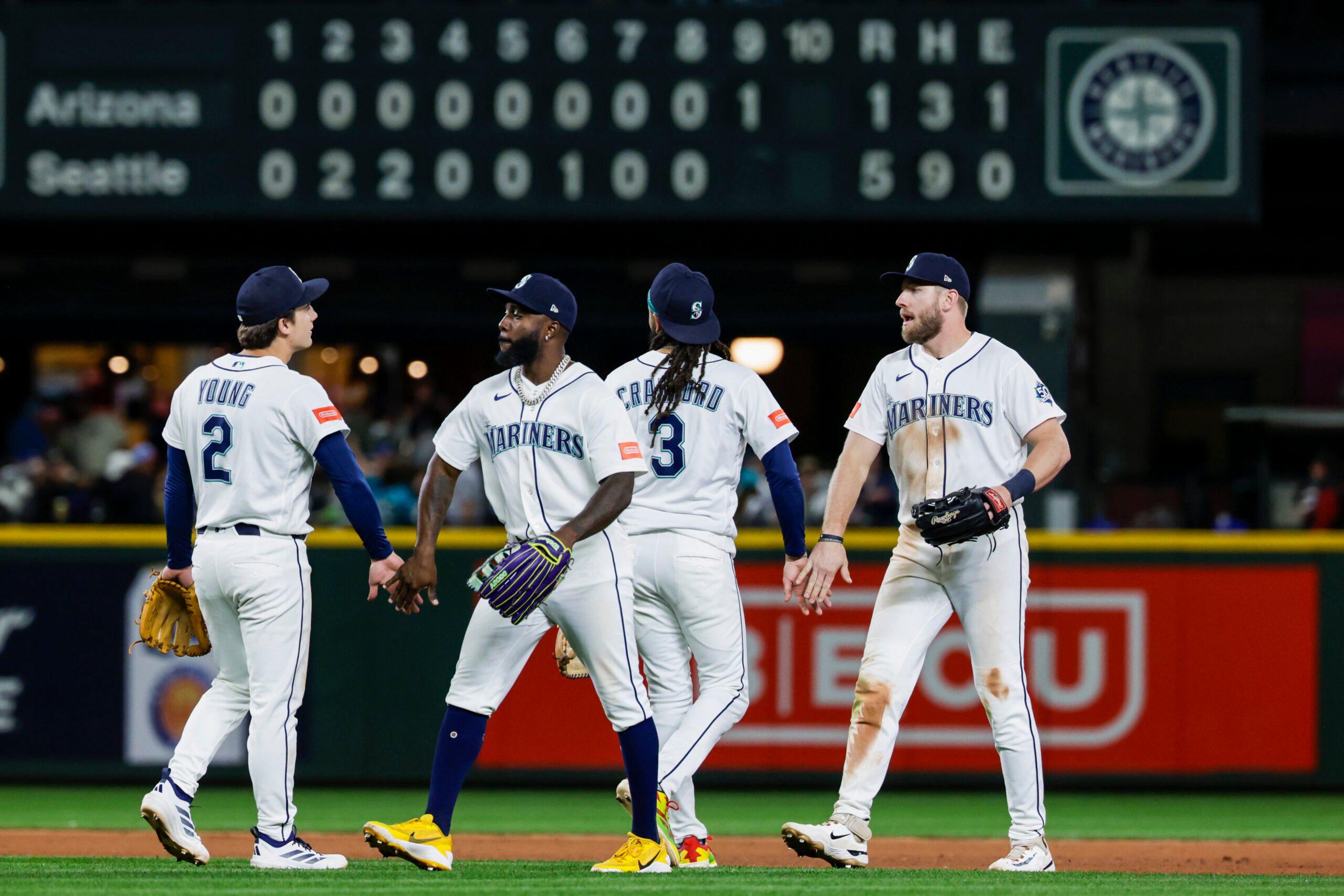 May 30, 2026; Seattle, Washington, USA; Seattle Mariners second baseman Cole Young (2), left fielder Randy Arozarena (56), shortstop J.P. Crawford (3) and right fielder Luke Raley (20) celebrate following the final out of a victory against the Arizona Diamondbacks at T-Mobile Park. Mandatory Credit: Joe Nicholson-Imagn Images