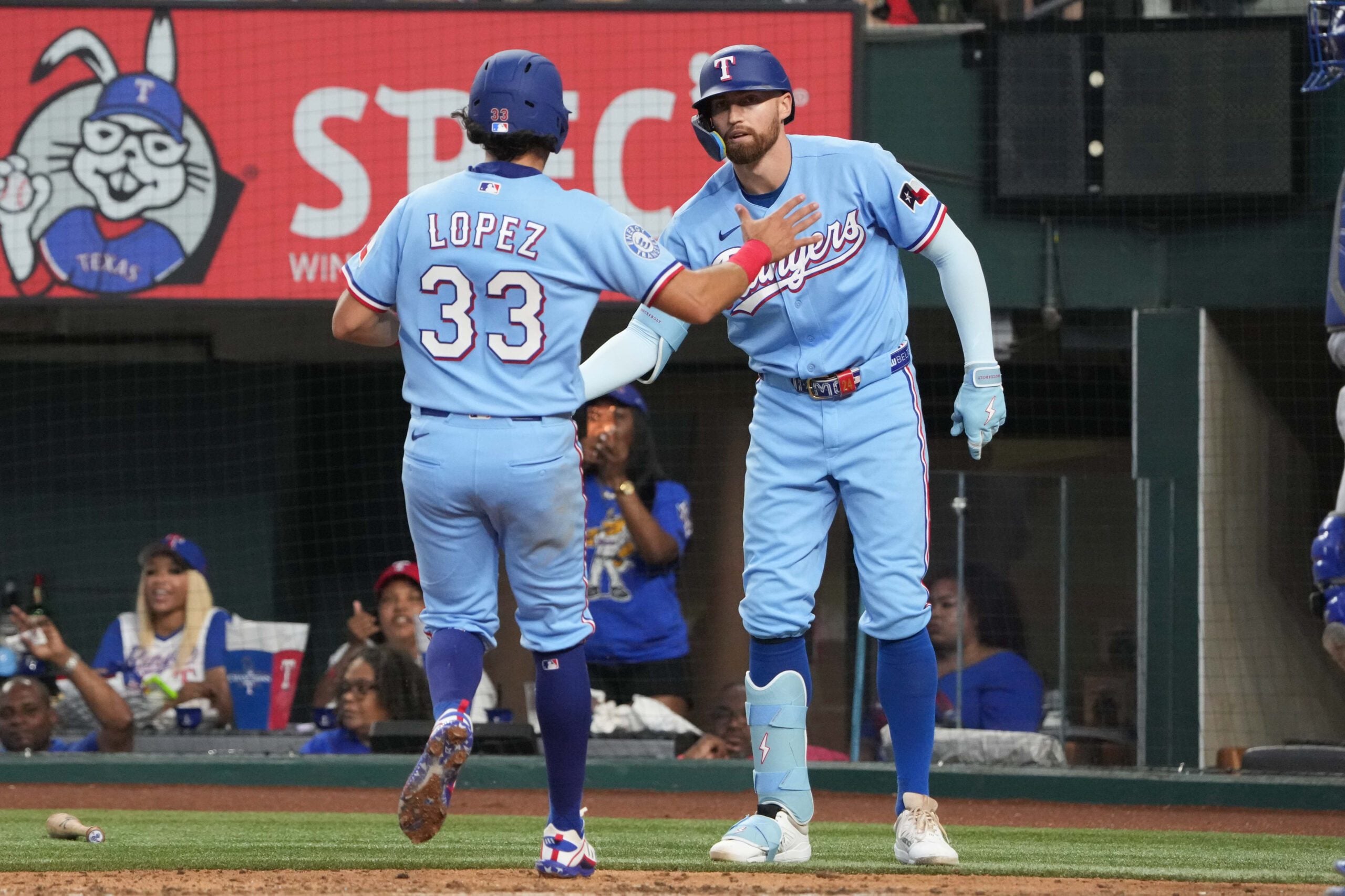 May 31, 2026; Arlington, Texas, USA; Texas Rangers second baseman Nicky Lopez (33) and Brandon Nimmo (24) celebrate scoring against the Kansas City Royals during the fourth inning at Globe Life Field. Mandatory Credit: Jim Cowsert-Imagn Images