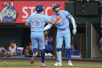 May 31, 2026; Arlington, Texas, USA; Texas Rangers second baseman Nicky Lopez (33) and Brandon Nimmo (24) celebrate scoring against the Kansas City Royals during the fourth inning at Globe Life Field. Mandatory Credit: Jim Cowsert-Imagn Images