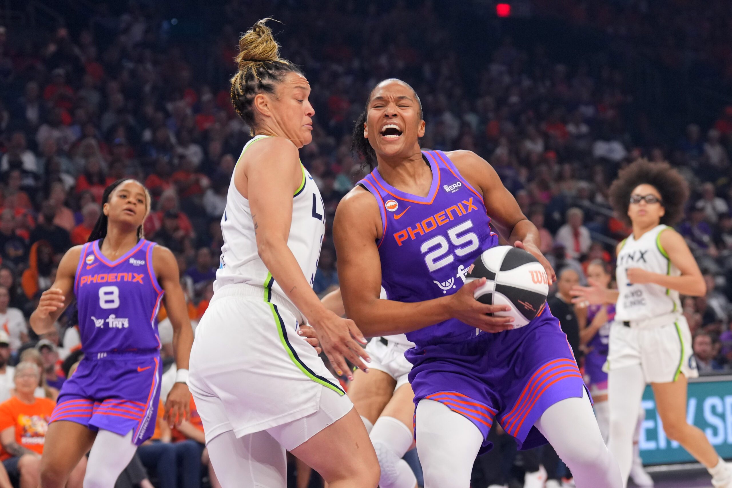Jun 1, 2026; Phoenix, Arizona, USA; Phoenix Mercury forward Alyssa Thomas (25) drives against Minnesota Lynx guard Kayla McBride (21) during the first half at Mortgage Matchup Center. Mandatory Credit: Joe Camporeale-Imagn Images