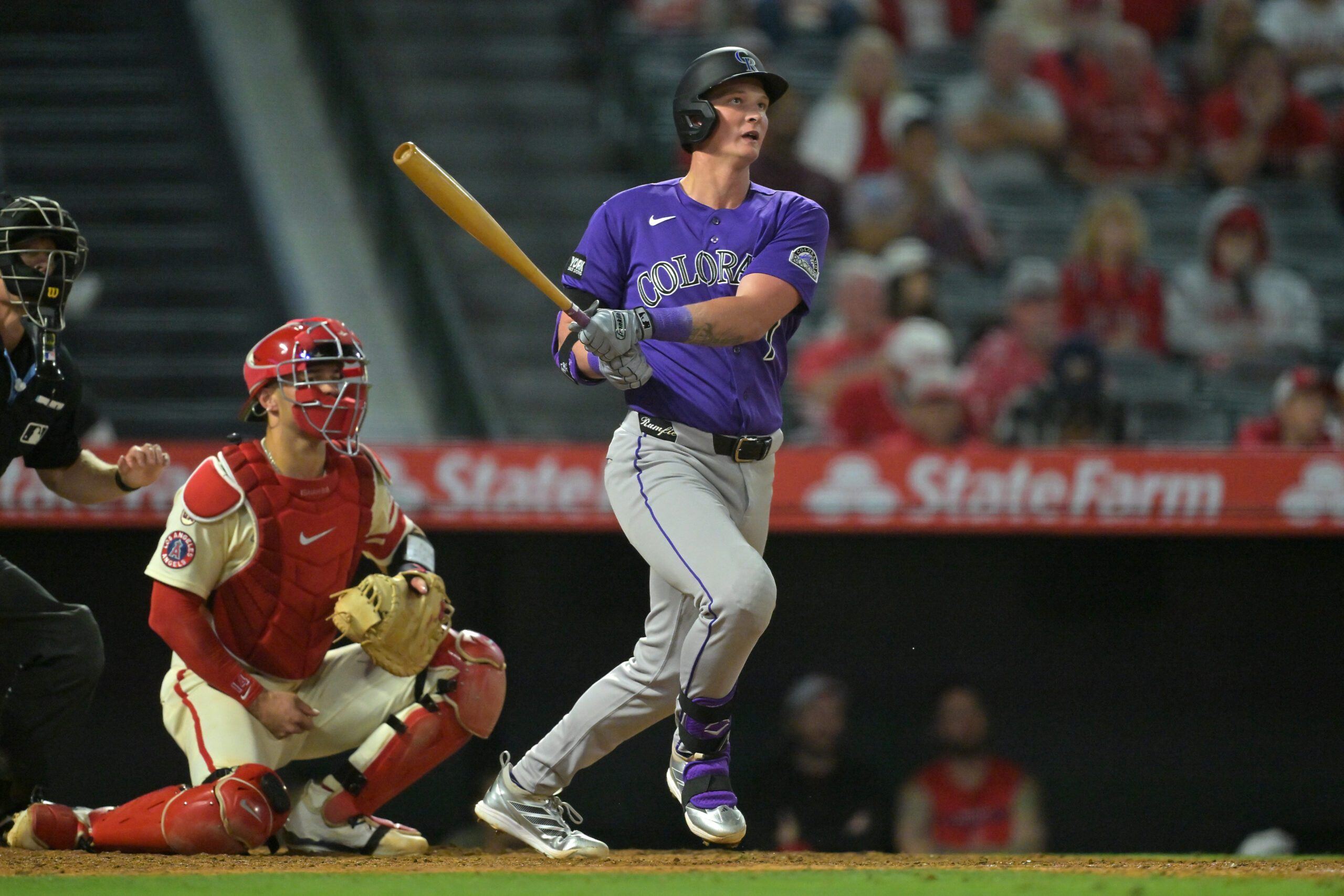 Jun 1, 2026; Anaheim, California, USA; Colorado Rockies first baseman TJ Rumfield (7) hits a sacrifice fly in the eighth inning to score the winning run against the Los Angeles Angels at Angel Stadium. Mandatory Credit: Jayne Kamin-Oncea-Imagn Images