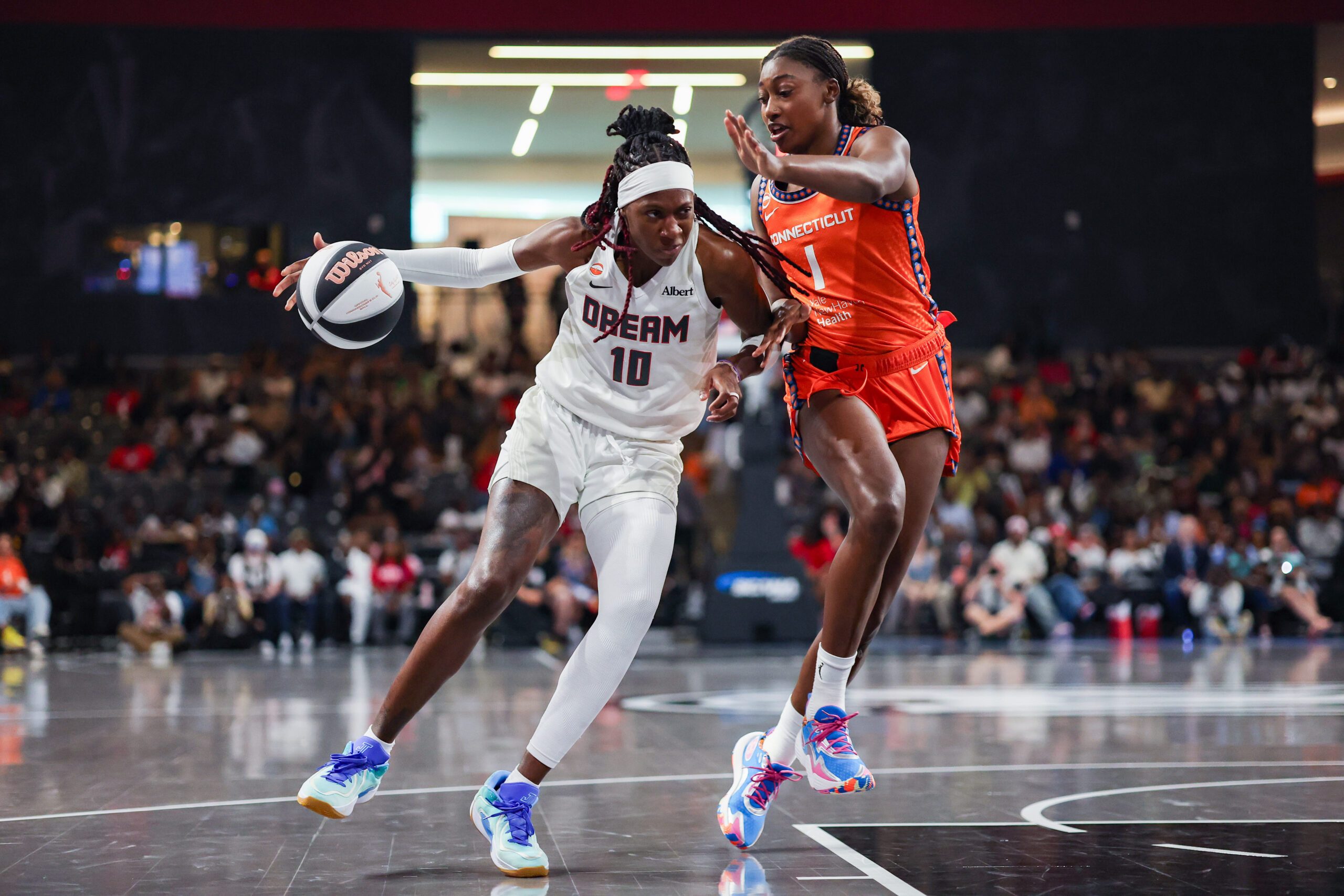 Jun 2, 2026; College Park, Georgia, USA; Atlanta Dream guard Rhyne Howard (10) drives on Connecticut Sun forward Diamond Miller (1) in the first quarter at Gateway Center Arena at College Park. Mandatory Credit: Brett Davis-Imagn Images
