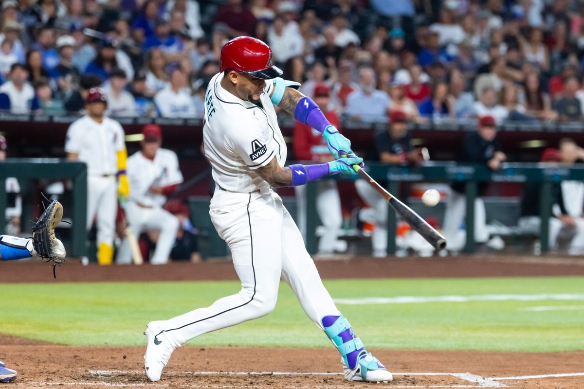Jun 2, 2026; Phoenix, Arizona, USA; Arizona Diamondbacks second baseman Ketel Marte hits a sacrifice fly to drive in a run in the fifth inning against the Los Angeles Dodgers at Chase Field. Mandatory Credit: Mark J. Rebilas-Imagn Images