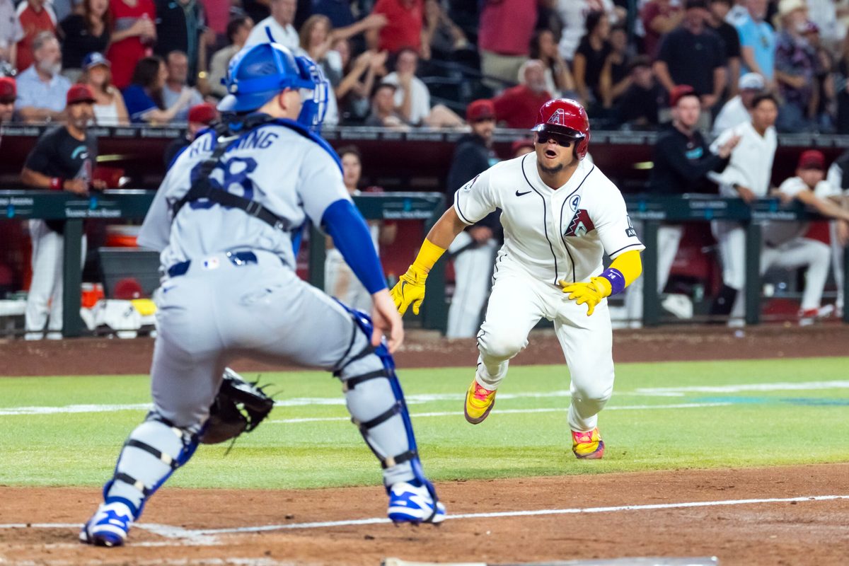 Jun 2, 2026; Phoenix, Arizona, USA; Arizona Diamondbacks base runner Gabriel Moreno (right) dives into home ahead of the tag by Los Angeles Dodgers catcher Dalton Rushing in the seventh inning at Chase Field. Mandatory Credit: Mark J. Rebilas-Imagn Images
