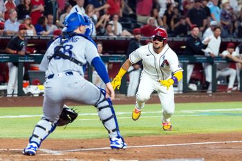 Jun 2, 2026; Phoenix, Arizona, USA; Arizona Diamondbacks base runner Gabriel Moreno (right) dives into home ahead of the tag by Los Angeles Dodgers catcher Dalton Rushing in the seventh inning at Chase Field. Mandatory Credit: Mark J. Rebilas-Imagn Images