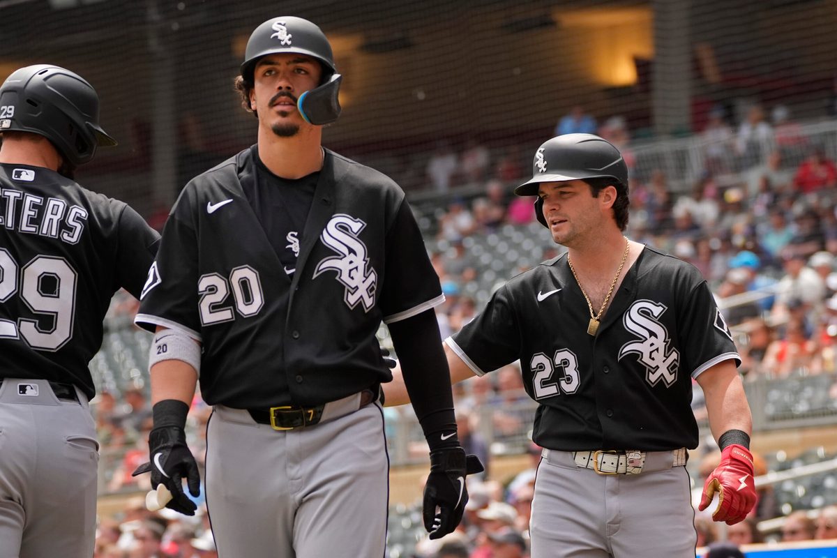 Jun 3, 2026; Minneapolis, Minnesota, USA; Chicago White Sox third baseman Miguel Vargas (20) and designated hitter Andrew Benintendi (23) celebrate their runs against the Minnesota Twins on a single by  first baseman Jacob Gonzalez (not pictured) in the first inning at Target Field. Mandatory Credit: Bruce Kluckhohn-Imagn Images