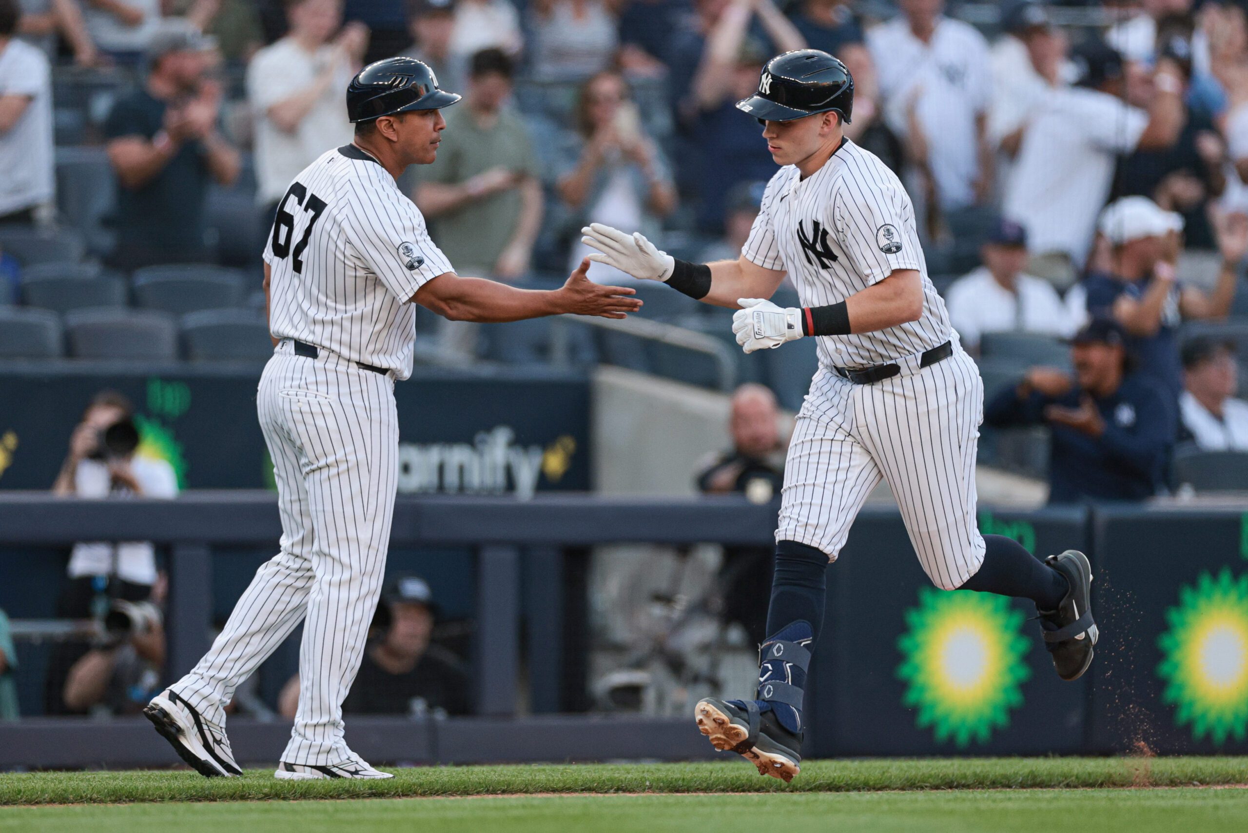 Jun 5, 2026; Bronx, New York, USA; New York Yankees first baseman Ben Rice (22) celebrates with third base/outfield coach Luis Rojas (67) after hitting a solo home run during the first inning against the Boston Red Sox at Yankee Stadium. Mandatory Credit: Vincent Carchietta-Imagn Images