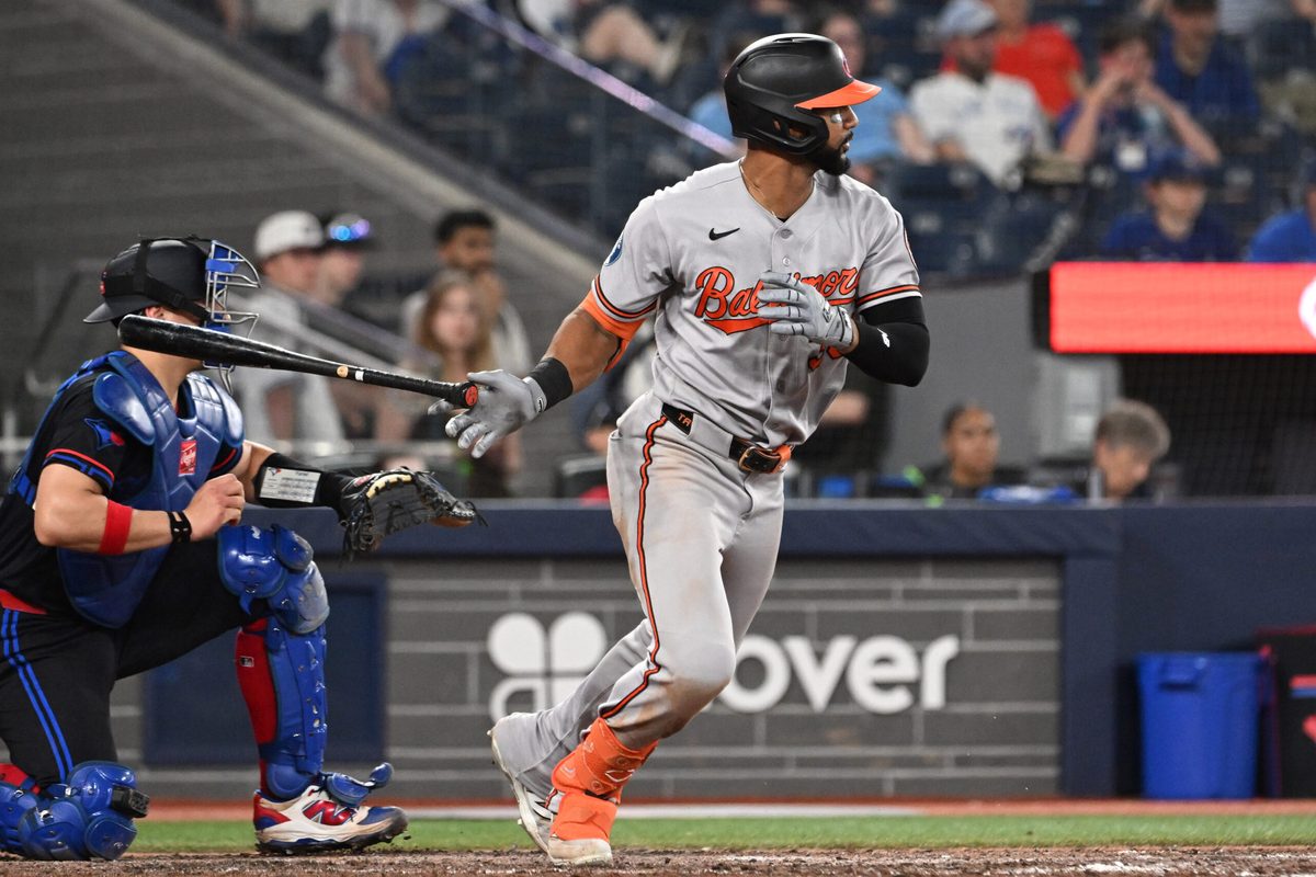 Jun 5, 2026; Toronto, Ontario, CAN; Baltimore Orioles center fielder Leody Taveras  (30) hits a ball that creates a Toronto Blue Jays throwing error that scores two runs in the ninth inning at Rogers Centre. Mandatory Credit: Dan Hamilton-Imagn Images