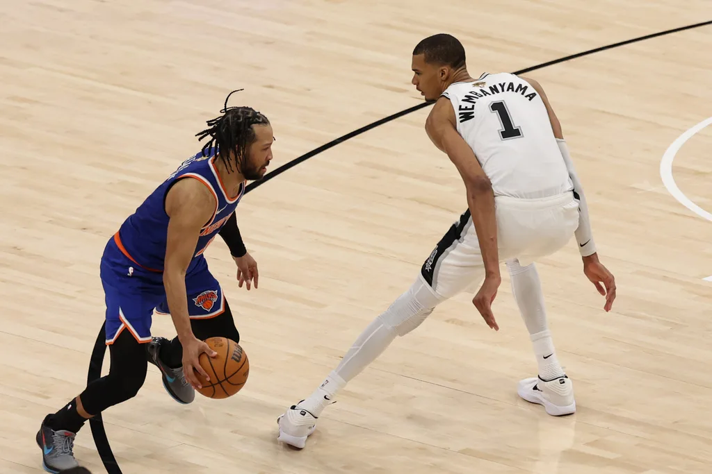Jun 5, 2026; San Antonio, Texas, USA; New York Knicks guard Jalen Brunson (11) dribbles the ball against San Antonio Spurs forward Victor Wembanyama (1) in the second half during game two of the 2026 NBA Finals at Frost Bank Center. Mandatory Credit: Geoff Burke-Imagn Images
