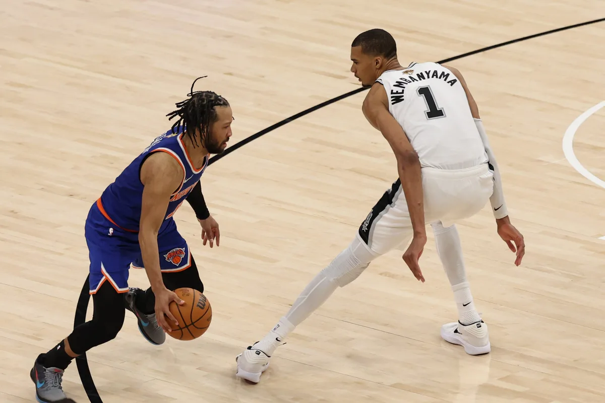 Jun 5, 2026; San Antonio, Texas, USA; New York Knicks guard Jalen Brunson (11) dribbles the ball against San Antonio Spurs forward Victor Wembanyama (1) in the second half during game two of the 2026 NBA Finals at Frost Bank Center. Mandatory Credit: Geoff Burke-Imagn Images
