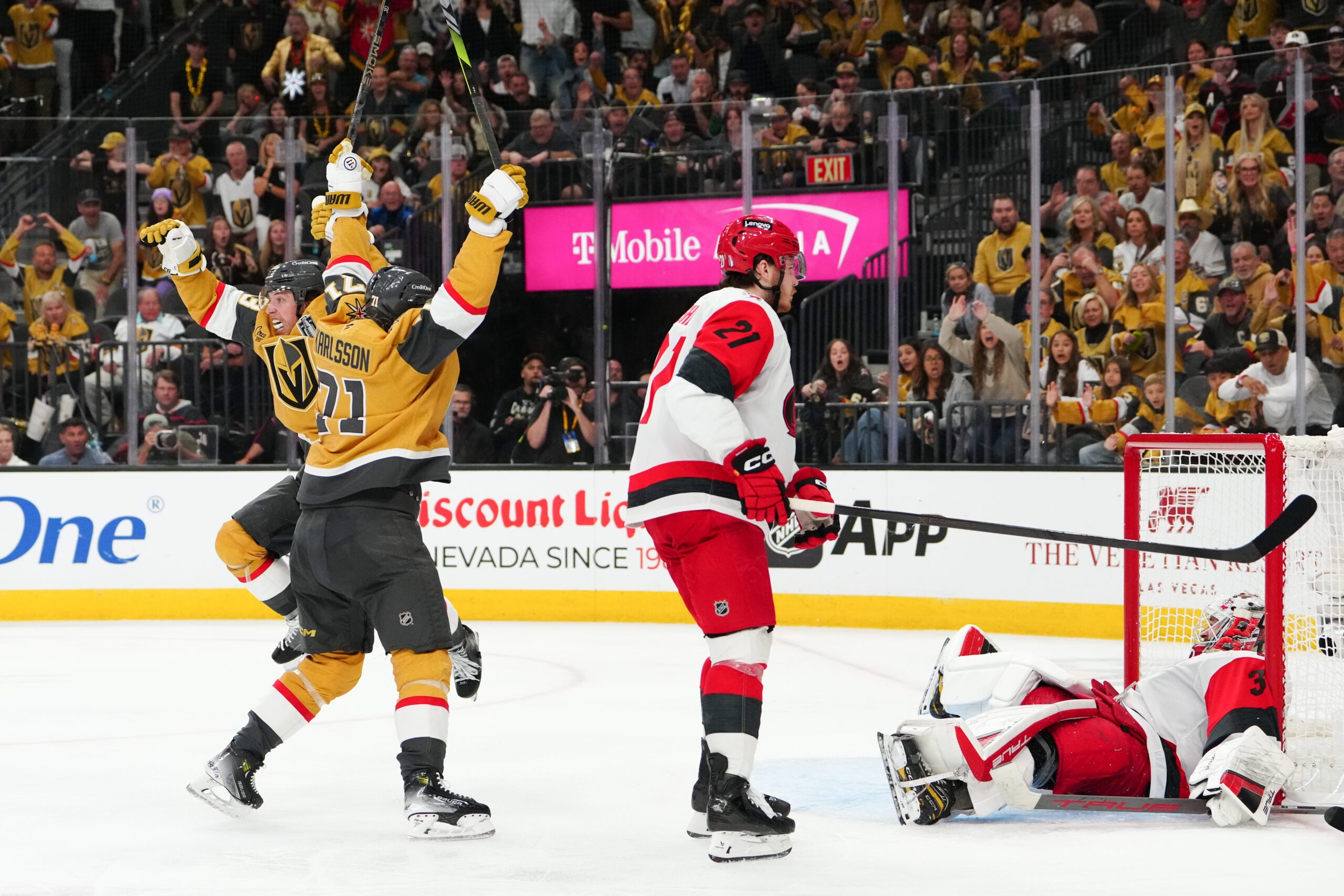 Jun 6, 2026; Las Vegas, Nevada, USA; Vegas Golden Knights right wing Mitch Marner (93) and center William Karlsson (71) celebrate after a goal by defenseman Shea Theodore (not pictured) as Carolina Hurricanes defenseman Alexander Nikishin (21) and goaltender Brandon Bussi (32) react during the second overtime in game three of the 2026 Stanley Cup Final at T-Mobile Arena. Mandatory Credit: Stephen R. Sylvanie-Imagn Images