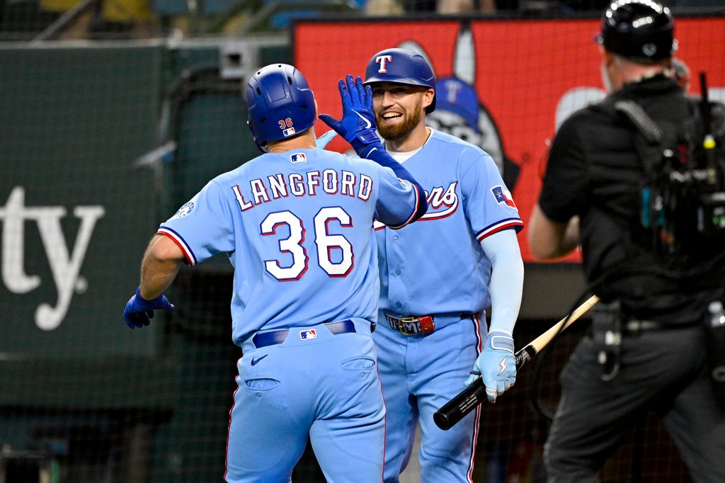 Jun 7, 2026; Arlington, Texas, USA; Texas Rangers left fielder Wyatt Langford (36) and right fielder Brandon Nimmo (24) celebrate after Langford hits a home run against the Cleveland Guardians during the fourth inning at Globe Life Field. Mandatory Credit: Jerome Miron-Imagn Images