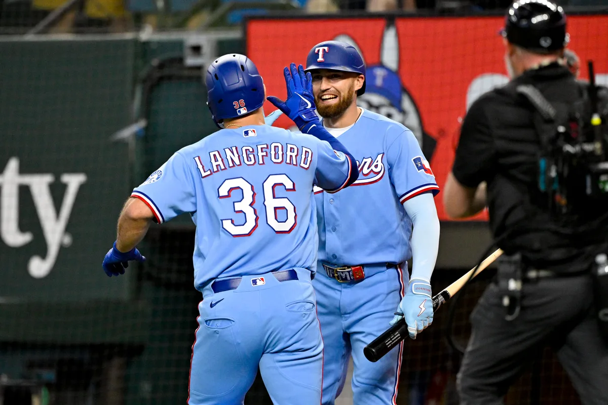 Jun 7, 2026; Arlington, Texas, USA; Texas Rangers left fielder Wyatt Langford (36) and right fielder Brandon Nimmo (24) celebrate after Langford hits a home run against the Cleveland Guardians during the fourth inning at Globe Life Field. Mandatory Credit: Jerome Miron-Imagn Images