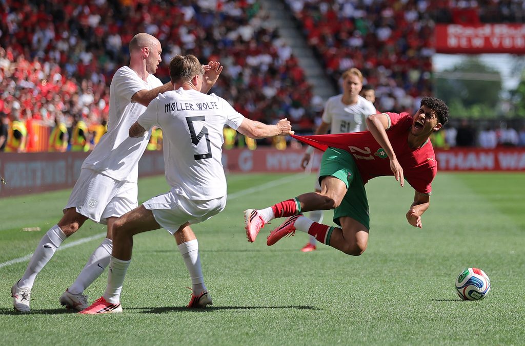 June 7, 2026; Harrison, New Jersey, U.S.; Norway's David Moller Wolfe pulls the jersey of Morocco's Ayoube Amaimouni-Echghouyab as Fredrik Aursnes looks on. Mandatory Credit: Brad Penner-Imagn Images