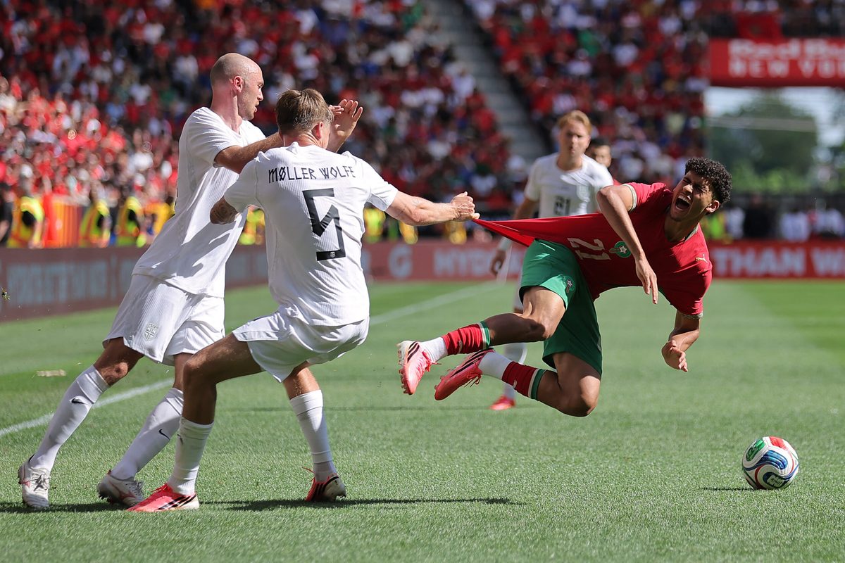 June 7, 2026; Harrison, New Jersey, U.S.; Norway's David Moller Wolfe pulls the jersey of Morocco's Ayoube Amaimouni-Echghouyab as Fredrik Aursnes looks on. Mandatory Credit: Brad Penner-Imagn Images