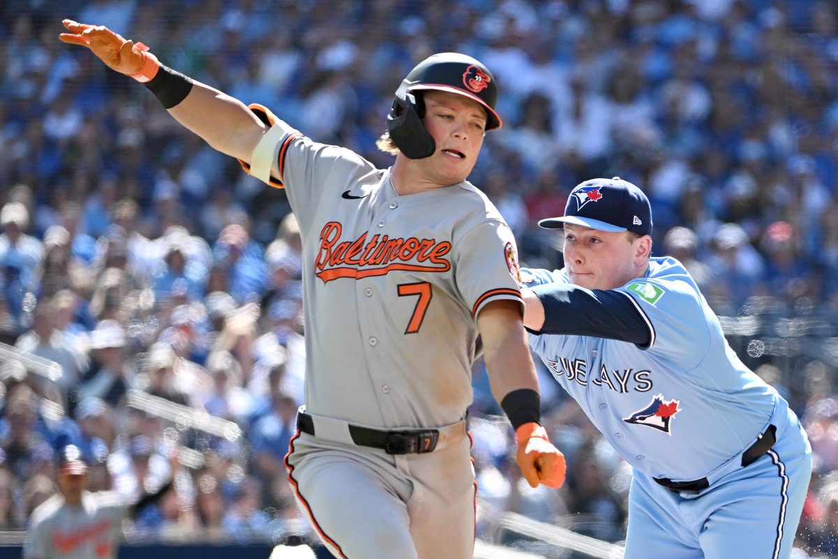 Jun 7, 2026; Toronto, Ontario, CAN;  Baltimore Orioles second baseman Jackson Holliday (7) is called out for running off the baseline to avoid a tage from Toronto Blue Jays pitcher Louis Varland (77) in the ninth inning at Rogers Centre. Mandatory Credit: Dan Hamilton-Imagn Images