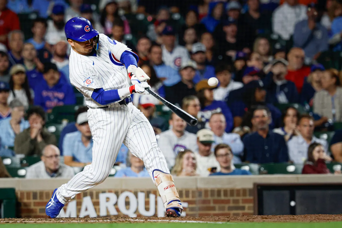 Jun 7, 2026; Chicago, Illinois, USA; Chicago Cubs right fielder Seiya Suzuki (27) singles against the San Francisco Giants during the sixth inning at Wrigley Field. Mandatory Credit: Kamil Krzaczynski-Imagn Images