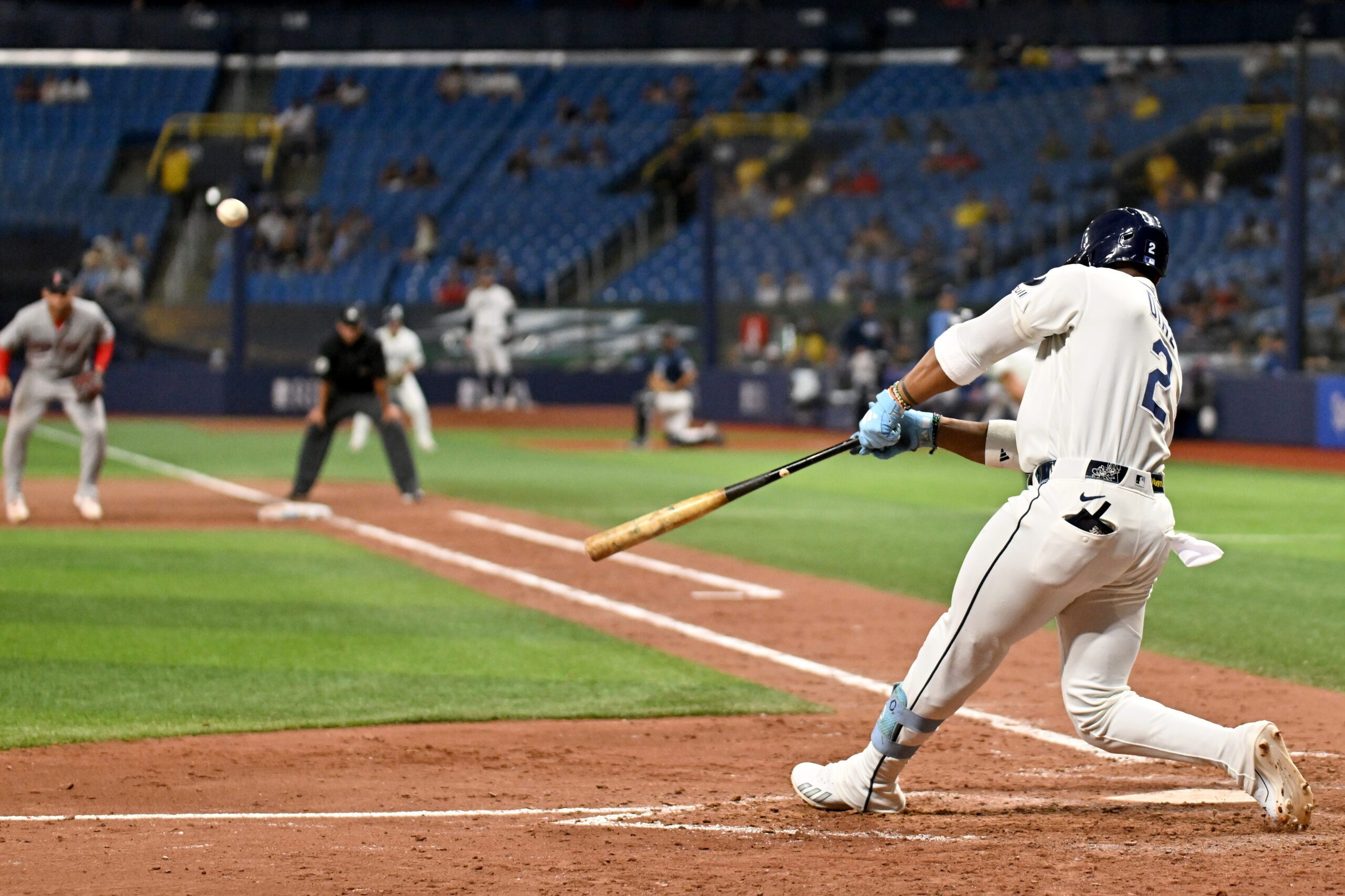 Jun 8, 2026; St. Petersburg, Florida, USA; Tampa Bay Rays designated hitter Yandy Diaz (2) hits an RBI sacrifice fly ball in the ninth inning against the Boston Red Sox at Tropicana Field. Mandatory Credit: Jonathan Dyer-Imagn Images