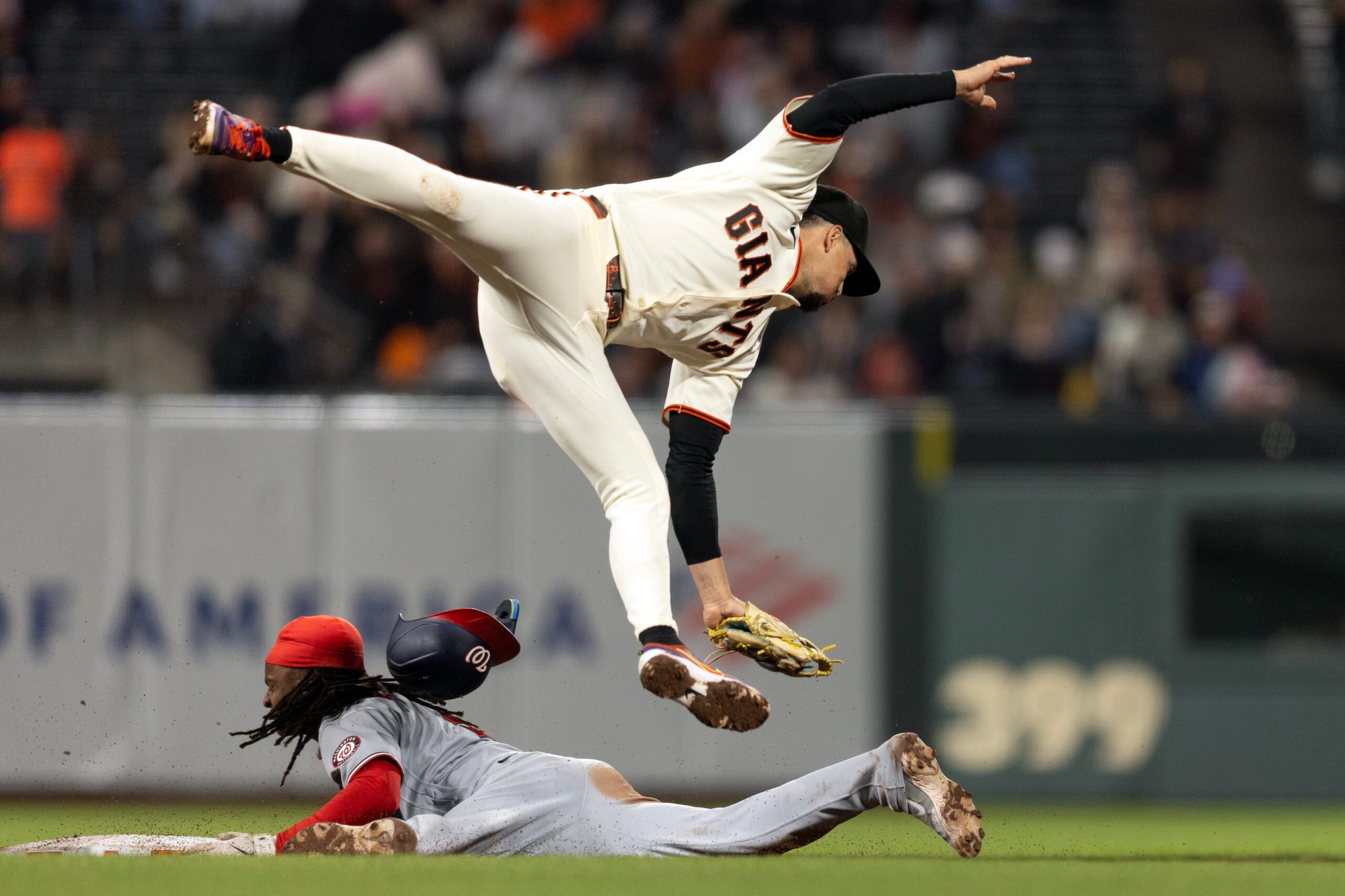 Jun 8, 2026; San Francisco, California, USA; San Francisco Giants shortstop Willy Adames (2) cannot reach an errant throw from the catcher as Washington Nationals shortstop CJ Abrams (5) slides safely into second with a stolen base during the ninth inning at Oracle Park. Mandatory Credit: D. Ross Cameron-Imagn Images