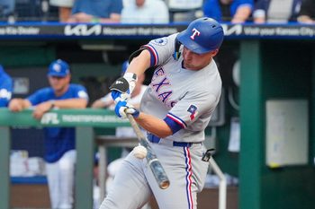 Jun 9, 2026; Kansas City, Missouri, USA; Texas Rangers shortstop Corey Seager (5) hits a single against the Kansas City Royals during the first inning at Kauffman Stadium. Mandatory Credit: Denny Medley-Imagn Images